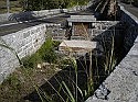 Historic well littered with trash and graffiti