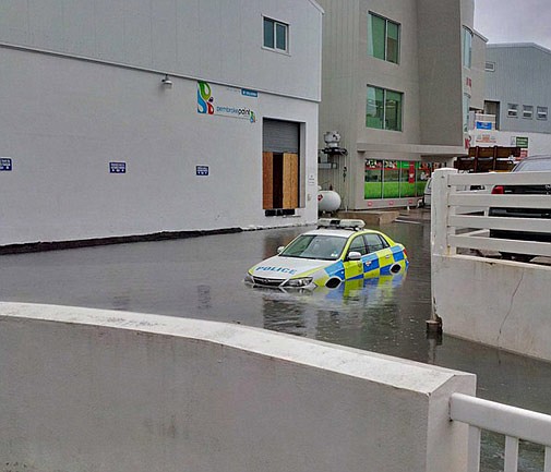 Cop car gets stuck in flooded street (update)